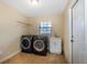 Well-lit laundry room with modern washer and dryer, sink and convenient storage shelving at 2661 Jennifer Hope Blvd, Longwood, FL 32779