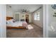 Spacious main bedroom with ceiling fan, large window and ensuite bathroom entrance at 2661 Jennifer Hope Blvd, Longwood, FL 32779