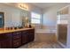 Bathroom with double vanity, garden tub, and separate glass-enclosed shower at 2904 Sweetspire Cir, Kissimmee, FL 34746