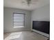 Bedroom with a ceiling fan and a large window with horizontal blinds at 2904 Sweetspire Cir, Kissimmee, FL 34746