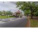 A guarded entrance to the community on a tree-lined street at 2904 Sweetspire Cir, Kissimmee, FL 34746