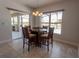 Dining area with modern lighting and views of the outdoor pool at 2904 Sweetspire Cir, Kissimmee, FL 34746