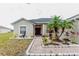 Inviting single-Gathering home with a decorative fountain, lush landscaping, and a brick pathway to the front door at 2904 Sweetspire Cir, Kissimmee, FL 34746