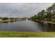 Scenic view of a tranquil pond surrounded by lush greenery and trees in the community at 2904 Sweetspire Cir, Kissimmee, FL 34746