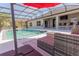 Inviting screened-in pool area with lounge seating and outdoor kitchen bar at 2904 Sweetspire Cir, Kissimmee, FL 34746