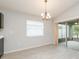 Dining area featuring tile flooring, a chandelier, window with blinds and sliding doors at 325 St Georges Cir, Eagle Lake, FL 33839