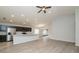 Bright living room with stainless steel appliances, bar seating, and sliding glass doors to the patio at 325 St Georges Cir, Eagle Lake, FL 33839