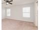 Spacious main bedroom with neutral carpet, large windows, and plenty of natural light at 325 St Georges Cir, Eagle Lake, FL 33839