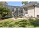 Relax on the patio with a view of the screened-in pool, surrounded by a well-manicured lawn at 3616 Indian Trl, Eustis, FL 32726