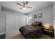 Cozy bedroom with carpet flooring and a spacious closet featuring a ceiling fan at 3616 Indian Trl, Eustis, FL 32726