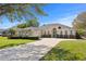 Charming home featuring a well-manicured lawn and inviting front facade with a large driveway at 3616 Indian Trl, Eustis, FL 32726