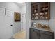 Hallway featuring a coffee bar with custom cabinetry and granite counters at 3616 Indian Trl, Eustis, FL 32726