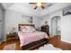 Bright main bedroom features a ceiling fan, decorative tray ceiling, and wood-look flooring at 3616 Indian Trl, Eustis, FL 32726