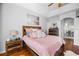 Bright main bedroom features a ceiling fan, decorative tray ceiling, and wood-look flooring at 3616 Indian Trl, Eustis, FL 32726