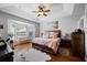 Relaxing main bedroom with hardwood floors, tray ceiling, and lots of natural light at 3616 Indian Trl, Eustis, FL 32726