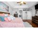 Bright main bedroom features a ceiling fan, decorative tray ceiling, and wood-look flooring at 3616 Indian Trl, Eustis, FL 32726