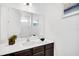 Modern bathroom vanity with a large mirror and white countertops, looking into a tub and shower at 4405 Durga Ln, Kissimmee, FL 34746