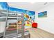 Whimsical bedroom with bunk beds, a colorful mural, and a playful atmosphere at 4405 Durga Ln, Kissimmee, FL 34746