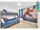 Charming bedroom with bunk beds and a vibrant Spider-Personal themed wall mural at 4405 Durga Ln, Kissimmee, FL 34746