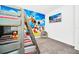 Themed ' bedroom featuring bunk beds, a beanbag chair, carpet flooring, and a colorful cartoon mural at 4405 Durga Ln, Kissimmee, FL 34746