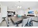 Open-concept dining area featuring a large table with seating and seamless transition to the modern kitchen and living room at 4405 Durga Ln, Kissimmee, FL 34746