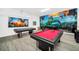 Game room features a pool table and vibrant wall art, perfect for Gathering fun at 4405 Durga Ln, Kissimmee, FL 34746