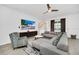 Inviting living room featuring a comfortable gray sectional, patterned accent chair, and scenic views from the window at 4405 Durga Ln, Kissimmee, FL 34746