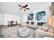 Living room featuring a sectional sofa, a table and chairs, contemporary artwork, and a ceiling fan at 4405 Durga Ln, Kissimmee, FL 34746