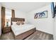 Comfortable main bedroom featuring carpet flooring, a king bed, modern art, and ambient bedside lamps at 4405 Durga Ln, Kissimmee, FL 34746