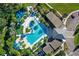 Top-down aerial shot of a pool, showing seating, landscaping and water features in a modern community at 4405 Durga Ln, Kissimmee, FL 34746