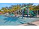 area in a community pool, with water slide, play area and seating for adults at 4405 Durga Ln, Kissimmee, FL 34746