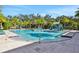 A community pool with ample seating, palm trees and a water slide and play area at 4405 Durga Ln, Kissimmee, FL 34746