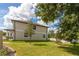 Exterior side view of a townhome featuring a well-maintained lawn and landscaping at 4409 Summer Flowers Pl, Kissimmee, FL 34746