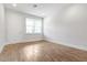 Bright living room with wood floors and window, offering ample natural light and a neutral backdrop at 4409 Summer Flowers Pl, Kissimmee, FL 34746