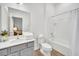 Bathroom vanity featuring a toilet, tub-shower combo, quartz countertop, and shaker cabinets at 4421 Durga Ln, Kissimmee, FL 34746