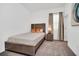 Bedroom featuring neutral paint and carpet, a bedside table with lamps, and closet at 4421 Durga Ln, Kissimmee, FL 34746