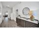 Inviting hallway with elegant decor, featuring a stylish console table, decorative mirror, and views of the living area at 4421 Durga Ln, Kissimmee, FL 34746