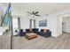 Welcoming living room showcasing wood floors, a ceiling fan, and an inviting L-shaped couch at 4421 Durga Ln, Kissimmee, FL 34746