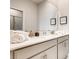 Elegant bathroom featuring double sinks, a large mirror, and framed inspirational prints at 2859 Bookmark Dr, Kissimmee, FL 34746