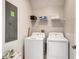 Laundry room featuring a washer, dryer, and wire shelving at 2859 Bookmark Dr, Kissimmee, FL 34746