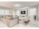 Modern living room with marble floors, a large sectional sofa, and an electric fireplace feature at 2859 Bookmark Dr, Kissimmee, FL 34746