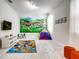 Bright playroom features a playful mural, colorful rug, tent, and table, perfect for entertainment at 2859 Bookmark Dr, Kissimmee, FL 34746