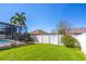 Expansive backyard featuring green grass and a screened pool area, perfect for outdoor living at 4770 Cypress Forest Ln, St Cloud, FL 34772