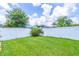 Grassy backyard featuring a white vinyl fence, perfect for outdoor activities and privacy at 4770 Cypress Forest Ln, St Cloud, FL 34772