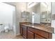 Bathroom features a granite vanity, a large mirror, and a tiled floor at 4770 Cypress Forest Ln, St Cloud, FL 34772