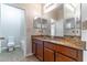 Bathroom featuring granite counters, modern cabinets, tile floors and views into water closet at 4770 Cypress Forest Ln, St Cloud, FL 34772