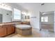 This bathroom features dual vanities, a tub, a tiled shower, and modern lighting at 4770 Cypress Forest Ln, St Cloud, FL 34772
