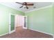 Bright bedroom showcases a ceiling fan, plush carpet and glass panel French doors at 4770 Cypress Forest Ln, St Cloud, FL 34772