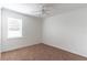 Bright bedroom with neutral carpet, ceiling fan, and a window for natural light at 4770 Cypress Forest Ln, St Cloud, FL 34772