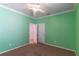 Bedroom with brown carpet, white trim and doors, light and fan fixture, and green walls at 4770 Cypress Forest Ln, St Cloud, FL 34772